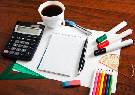 Desk with sheet of paper and stationery objects seen from aboveの写真素材