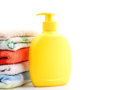 Towels and Soap Dispenser isolated on whiteの写真素材