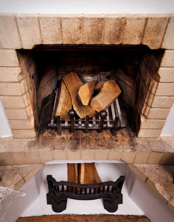 vintage antique fireplace with dry firewoodの写真素材