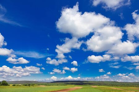village landscape with blue sky and incredible cloudsの写真素材