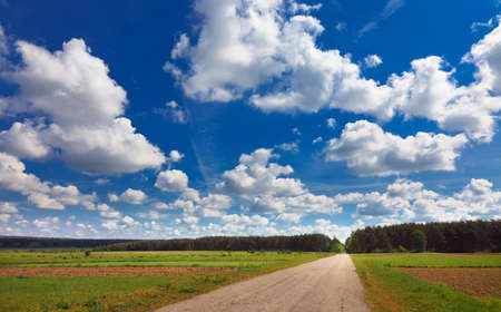 rural landscape with road and incredible cloudsの写真素材
