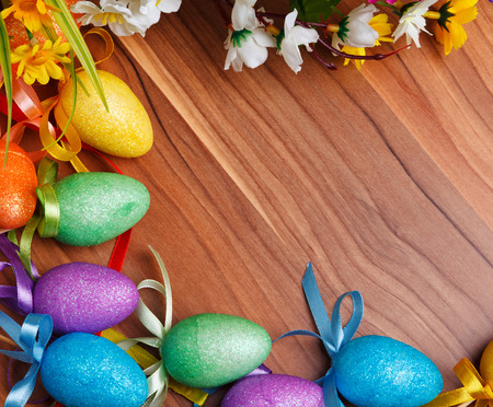 Easter background with colored eggs and flowersの写真素材