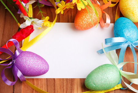 Easter greeting card with flowers and colorful eggsの写真素材