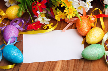 Easter greeting card with flowers and colorful eggsの写真素材
