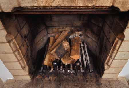vintage antique fireplace with dry firewoodの写真素材