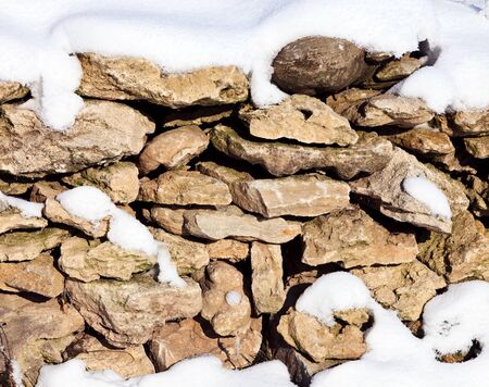 stones covered with snowの写真素材
