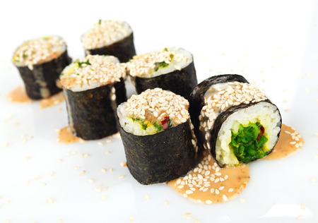 Traditional japanese sushi with sauce and sesame seeds isolated on white backgroundの写真素材