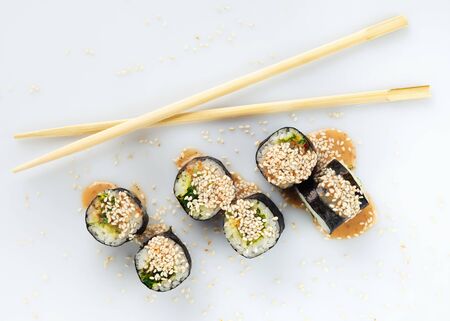 Traditional japanese sushi sprinkled with sesame seeds isolated on white background top viewの写真素材