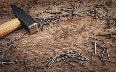 Hammer and nails on wooden background with  copyspaceの写真素材
