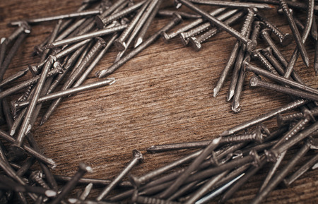 iron nails on wooden background wits copyspaceの写真素材
