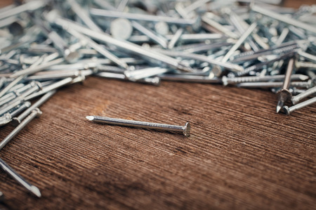 iron nails on wooden backgroundの写真素材