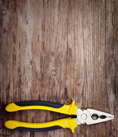 handtools plier on vintage wooden board constructionの写真素材