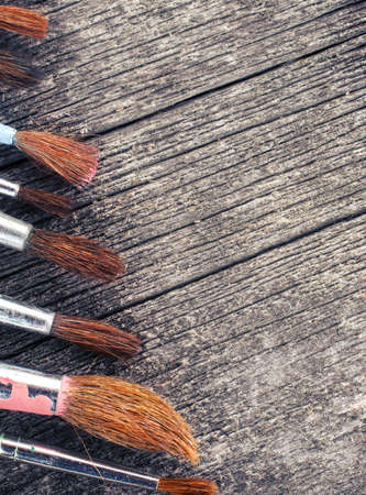 brushes for painting  on vintage wooden  backgroundの写真素材
