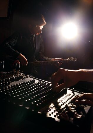 handsome guitarist recording and playing guitarの写真素材
