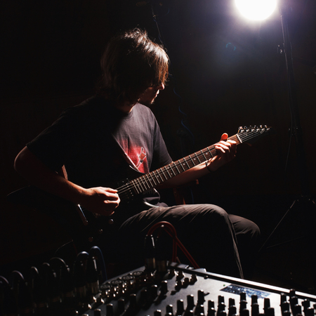 handsome guitarist recording and playing guitarの写真素材