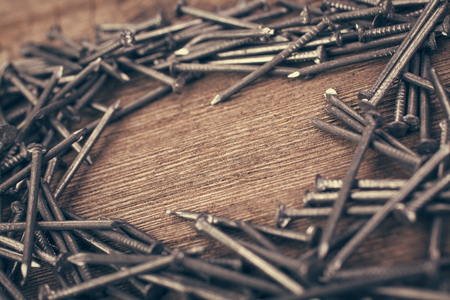 iron nails on wooden background wits copyspaceの写真素材