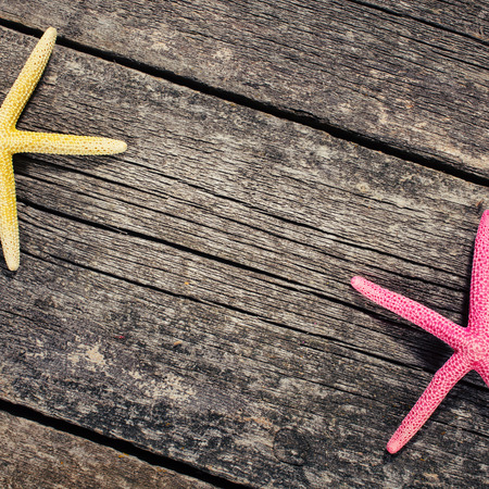 Starfish on old wooden background. space for textの写真素材