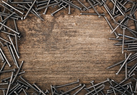 iron nails on wooden background wits copyspaceの写真素材