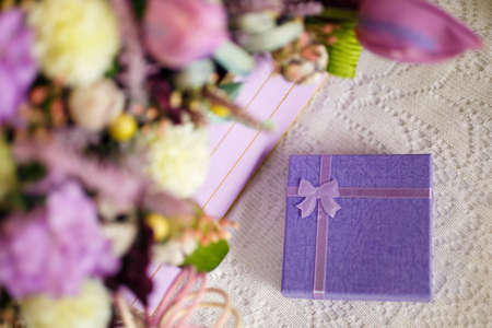 floral decoration with violet box for a gift, place for textの写真素材