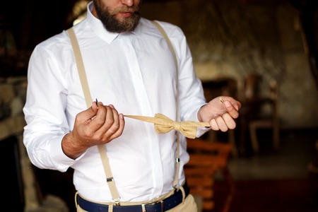 bearded groom going to a wedding, wearing yellow bow tieの写真素材