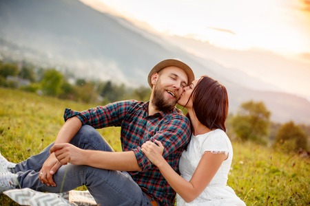 happy loving couple in the mountains . the atmosphere of the sunset. Love concept.の写真素材