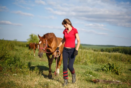 Happy Woman with her Horse - Beautiful young horsewoman next to her horse. equestrianの写真素材