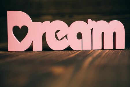 dream text on wooden background with space for textの写真素材