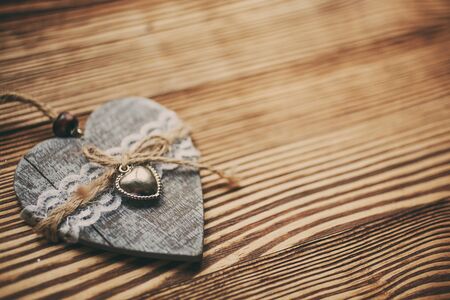 Romantic heart on wooden background, lovely greeting card with copy space.