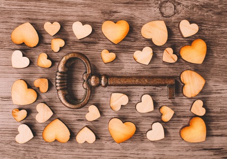 key to heart on wooden backgroundの写真素材