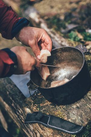 Preparing food on campfire in wild campingの写真素材