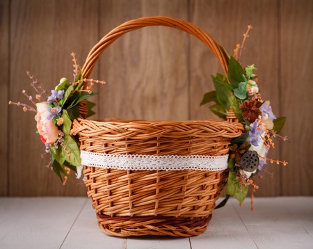 basket with flowers to celebrate Easter on a wooden backgroundの写真素材