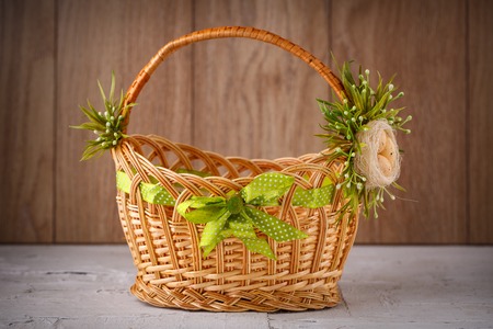 Originally decorated by flowers basket on a wooden backgroundの写真素材