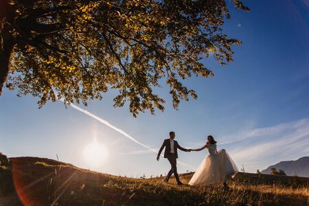 Lovely wedding couple on sunset at Carpathian mountains.の写真素材