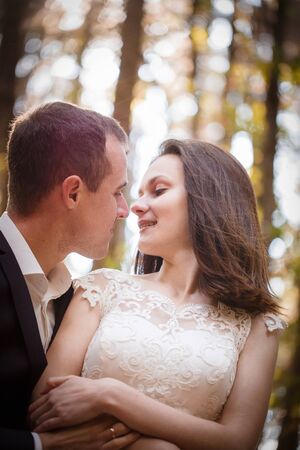 Beautiful couple in love on a walk in autumn forestの写真素材