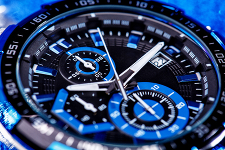 close up view of nice man's wrist watch on blue backgroundの写真素材