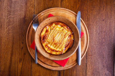 Sweet rice pudding baked in pottery. Sweet dish at the restaurant. Pudding with caramel