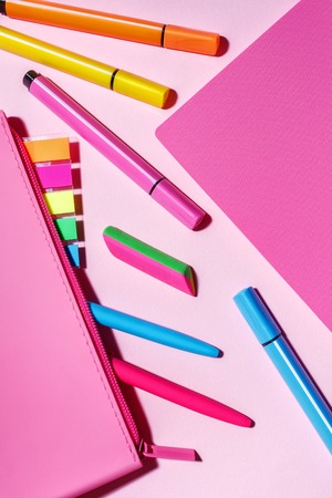 School stationery. Color markers, pens next to the pencil case. Bright stickers in the pencil case....