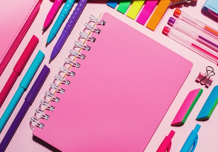 Along with the notebook colored pens, bright elastics in the form of a triangle. Flat lay, top view. place for textの写真素材