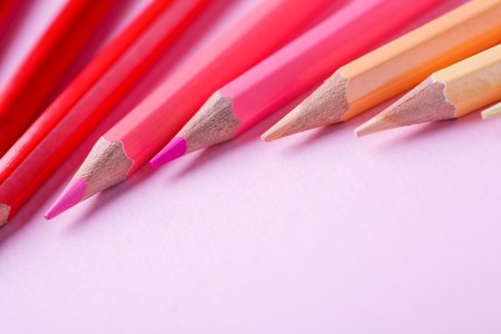 Color pencils lying on pastel pink background.の写真素材