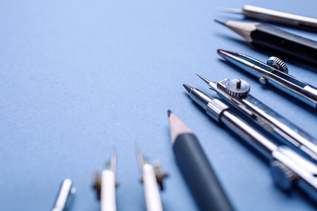 The compass, along with other tools for drawing on the blue background