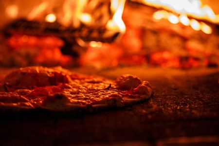 Pizza in the ovenの写真素材