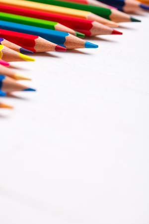 Pile of sharp coloured drawing pencils on table. Back to school conceptの写真素材