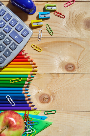 A group of stationery on the left side of the wooden background. Top view, flat lay. copyspaceの写真素材