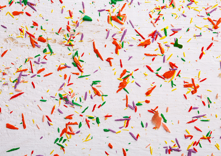 Copy space place for postcard wish. Abstract background from color pencils. Top view, flat lay. copyspace. Shavings from colored pencils on a white backgroundの写真素材