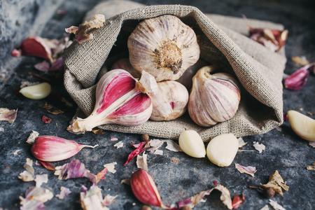 Peeled garlic cloves. Garlic scattered out of the sackの写真素材