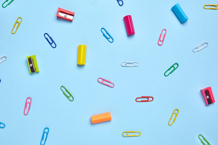 On the light blue table scattered a bright stationery. Colorful Back to School background. Top view, flat lay.の写真素材