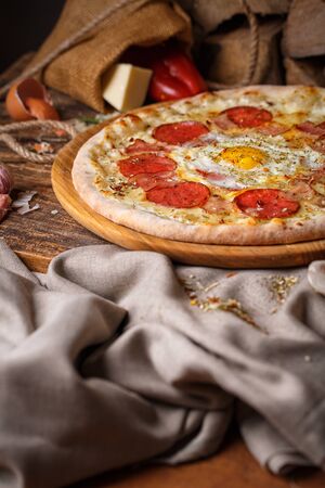Pizza with egg on the background of the ingredientsの写真素材