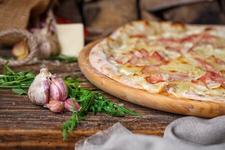 Garlic with a sleeve near the fragrant pizzaの写真素材