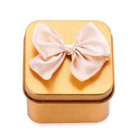 Single gold gift box with bow isolated on white background. Top viewの写真素材