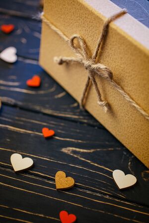 Brown gift boxes on wooden background with a bow of a simple rope closeupの写真素材